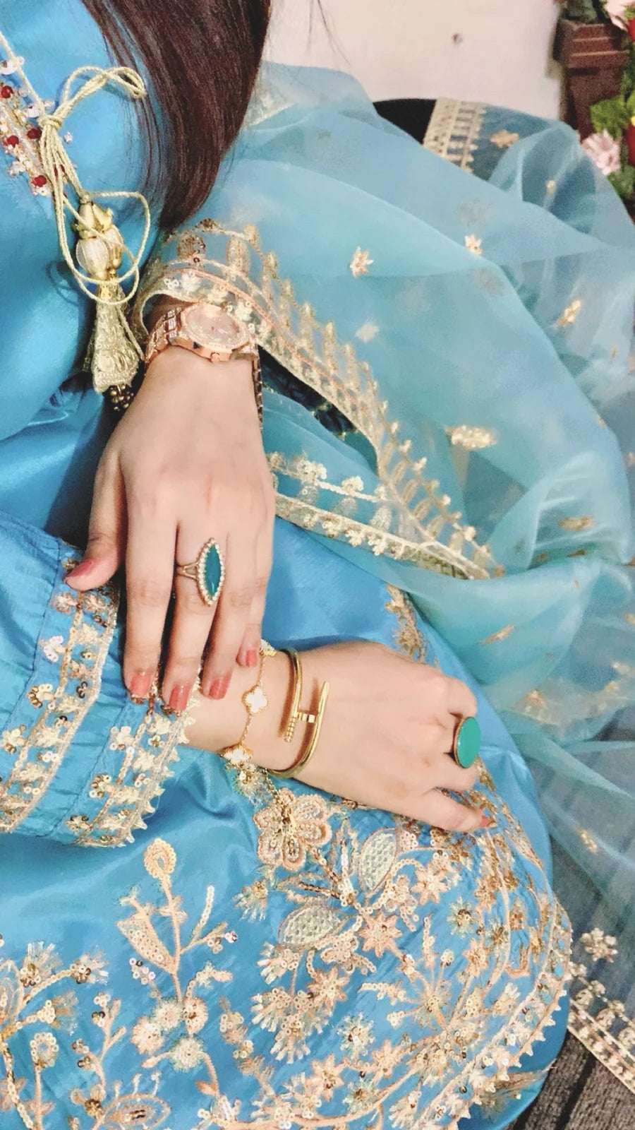 Detailed golden floral embroidery and sequin work on the sky blue China silk Farshi Shalwar suit.