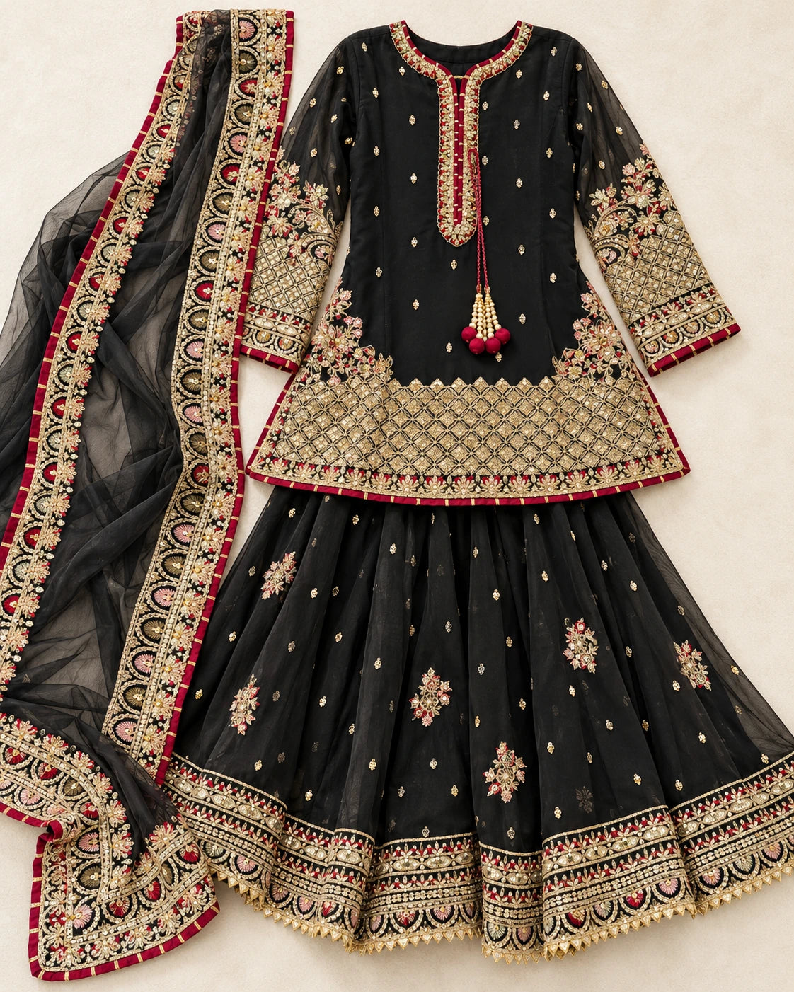 Complete black embroidered 3-piece sharara outfit featuring gold detailing, flared bottoms and net dupatta